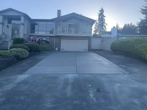 New concrete driveway running to a two car garage in Bothell, WA