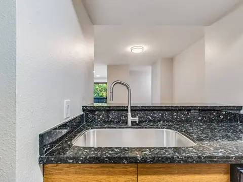 Stainless sink and dark granite counter in a remodeled Renton, WA kitchen