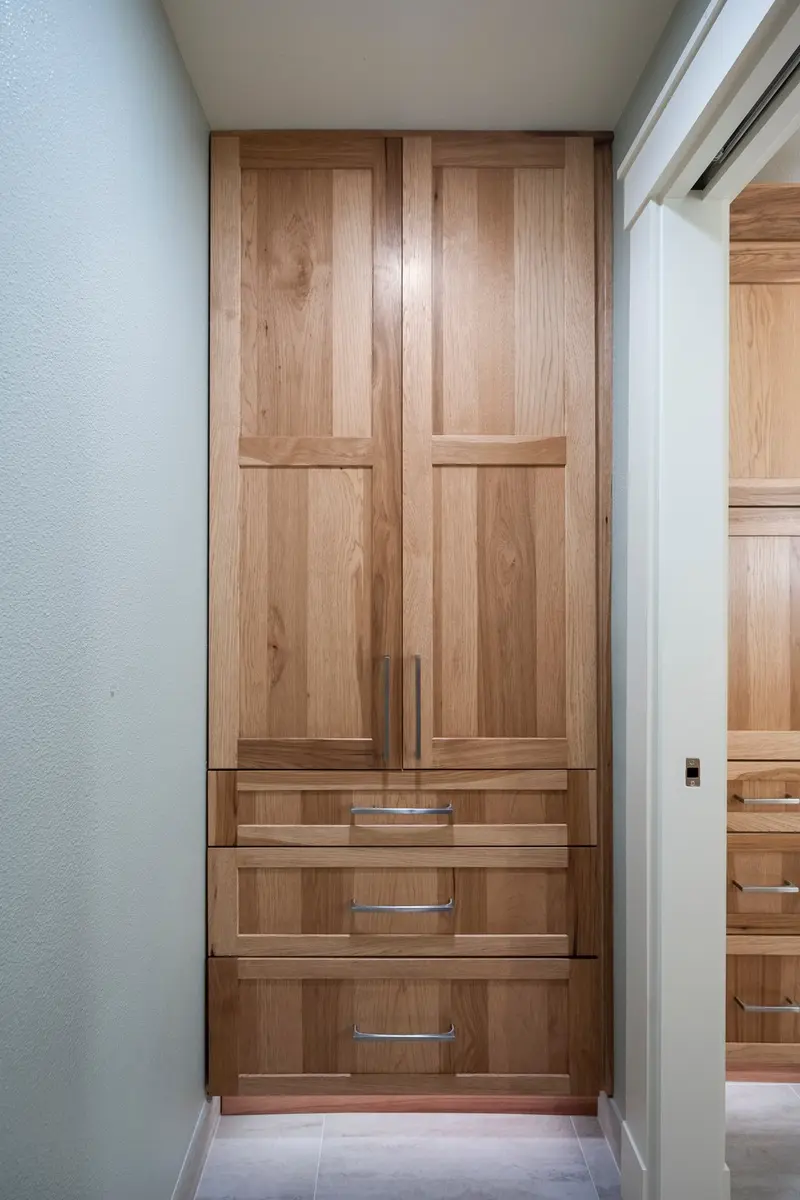 Full-height wood linen cabinet with two upper doors and three drawers