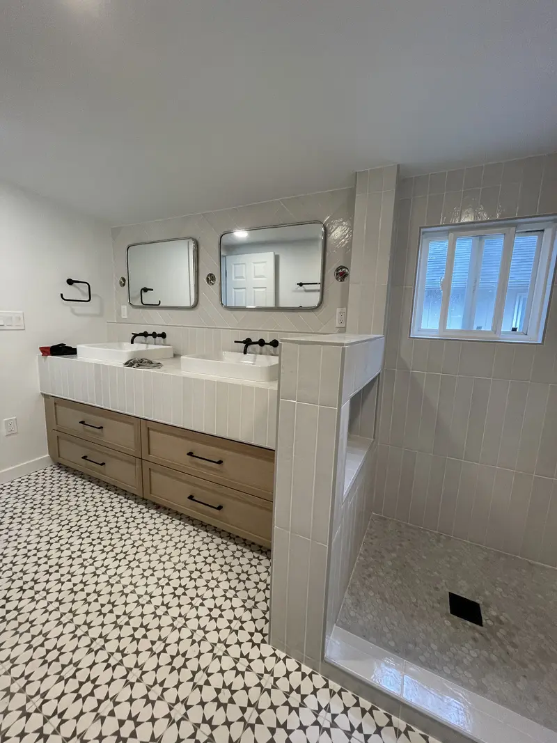 Shower curb and half wall at the end of a long vanity run