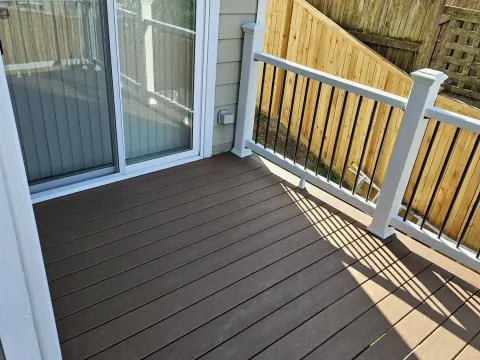Deck and railing by a sliding door by Volcano Builders