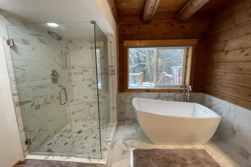Master bathroom remodeled by Volcano Builders: frameless glass shower, soaking tub and cedar paneled walls