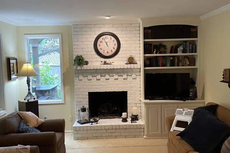 Living room remodel in Sammamish by Volcano Builders, white painted brick fireplace and built-in bookshelves