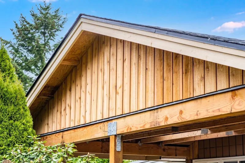 New cedar board and batten gable under a fresh shingle roof edge, from an Auburn project by Volcano Builders