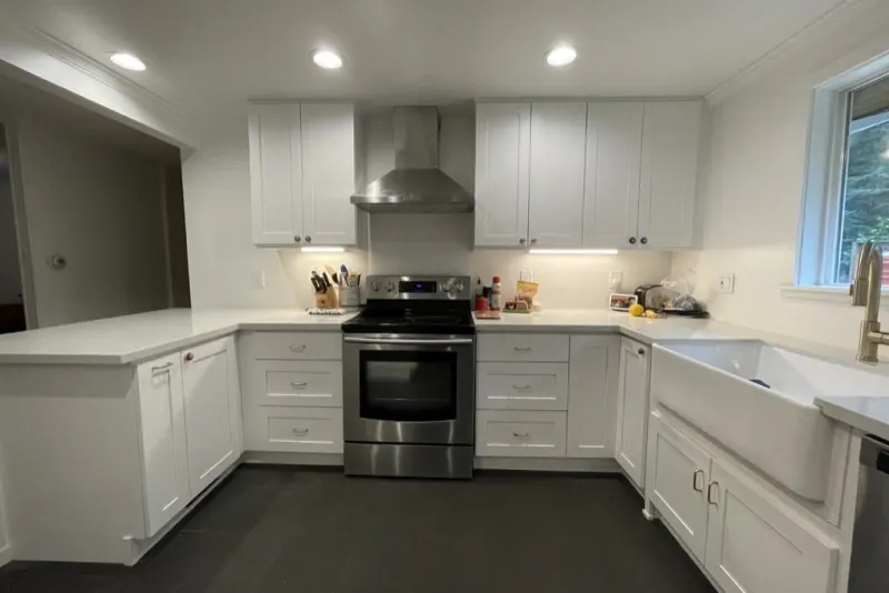 Kitchen remodel in Shoreline by Volcano Builders, white shaker cabinets, stainless range and farmhouse sink