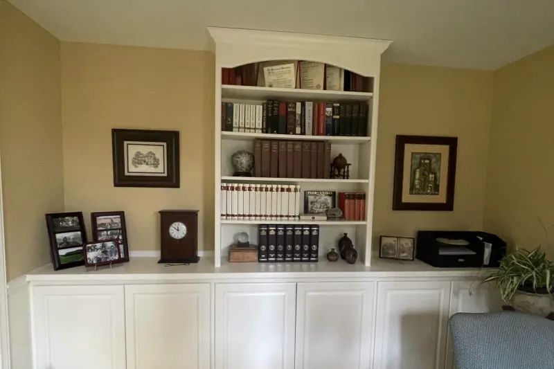 White built-in bookcase and cabinet run in a home office from a Sammamish remodel by Volcano Builders