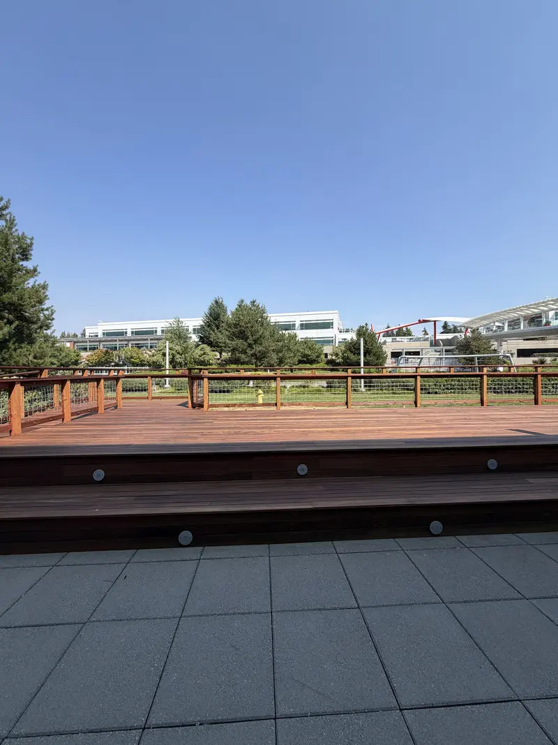 Front of the refinished raised deck platform with wide steps and small step lights, seen from the patio