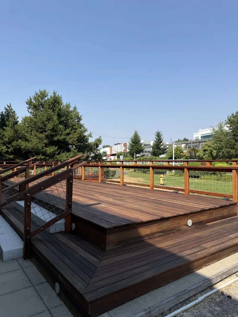 Side of the refinished raised platform with wide steps down to the lower deck