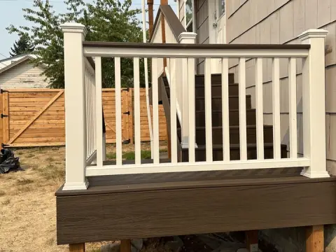 Deck stairs with white railings in a Seattle, WA backyard