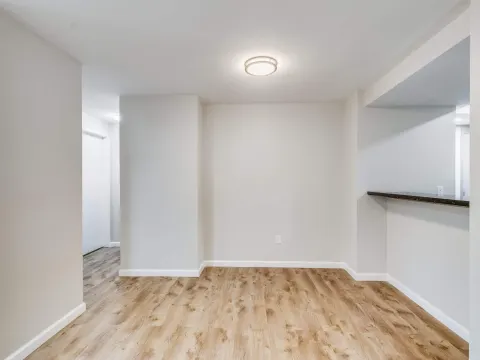 Light wood look laminate in a hallway with white walls in Renton, WA