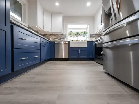 Navy and white kitchen with stainless appliances in Lynnwood, WA