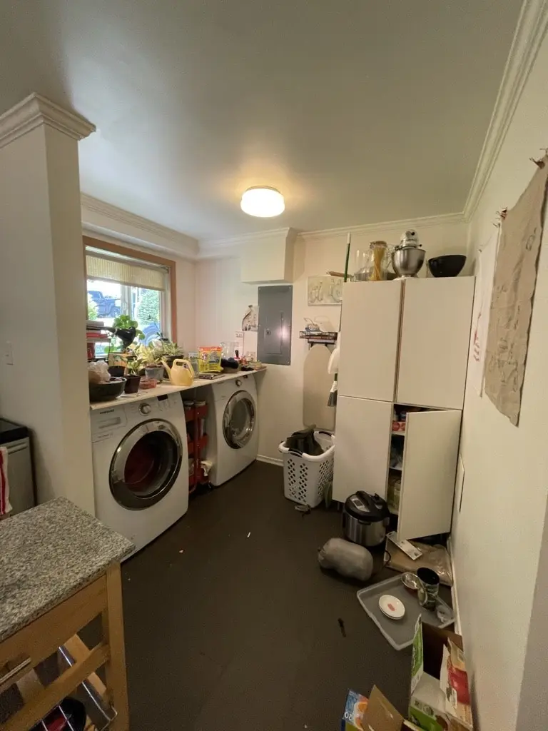 Corner of the old kitchen with a front-load washer and a doorway