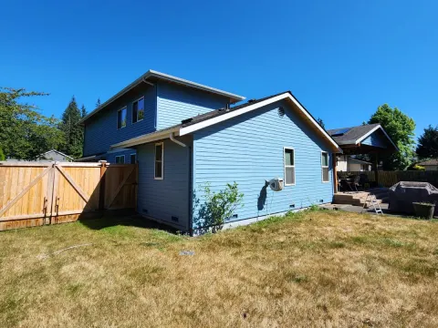 Rear corner of a house in Marysville, WA after an exterior repaint in blue