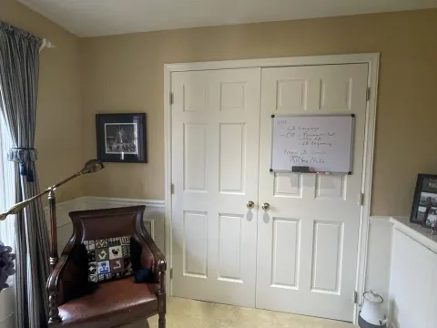 Double doors and white wainscoting in a repainted home office in Sammamish, WA