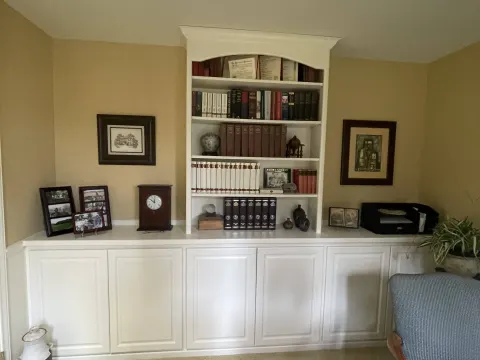 Sammamish, WA home office with built-in shelves and cabinets painted white against tan walls