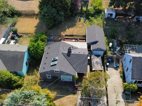 Wide aerial view of a repaired shingle roof among neighboring houses in Seattle, WA