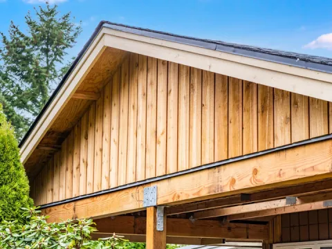 Close view of vertical board and batten siding on a new carport gable in Auburn, WA