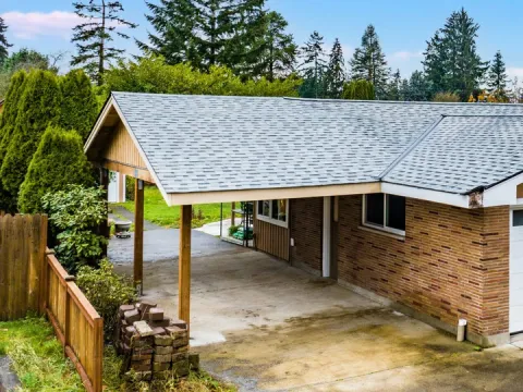 Rebuilt carport with a board and batten gable end and a shingle roof in Auburn, WA