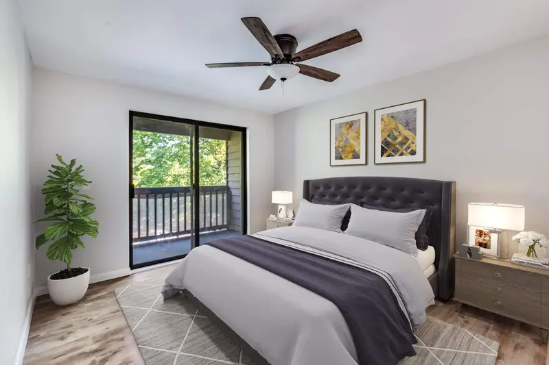 Bedroom with a ceiling fan, plank floor and a sliding door to the balcony