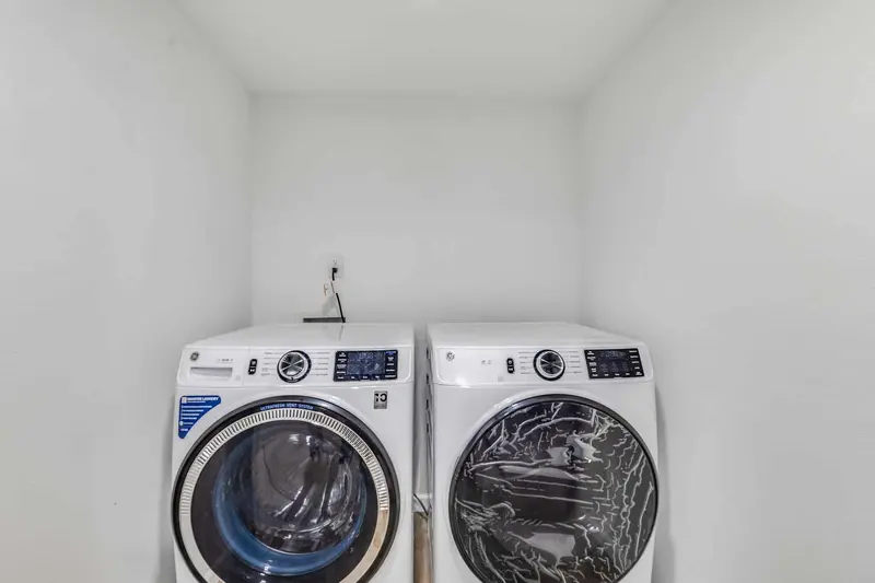 Laundry closet with a front loading washer and dryer side by side