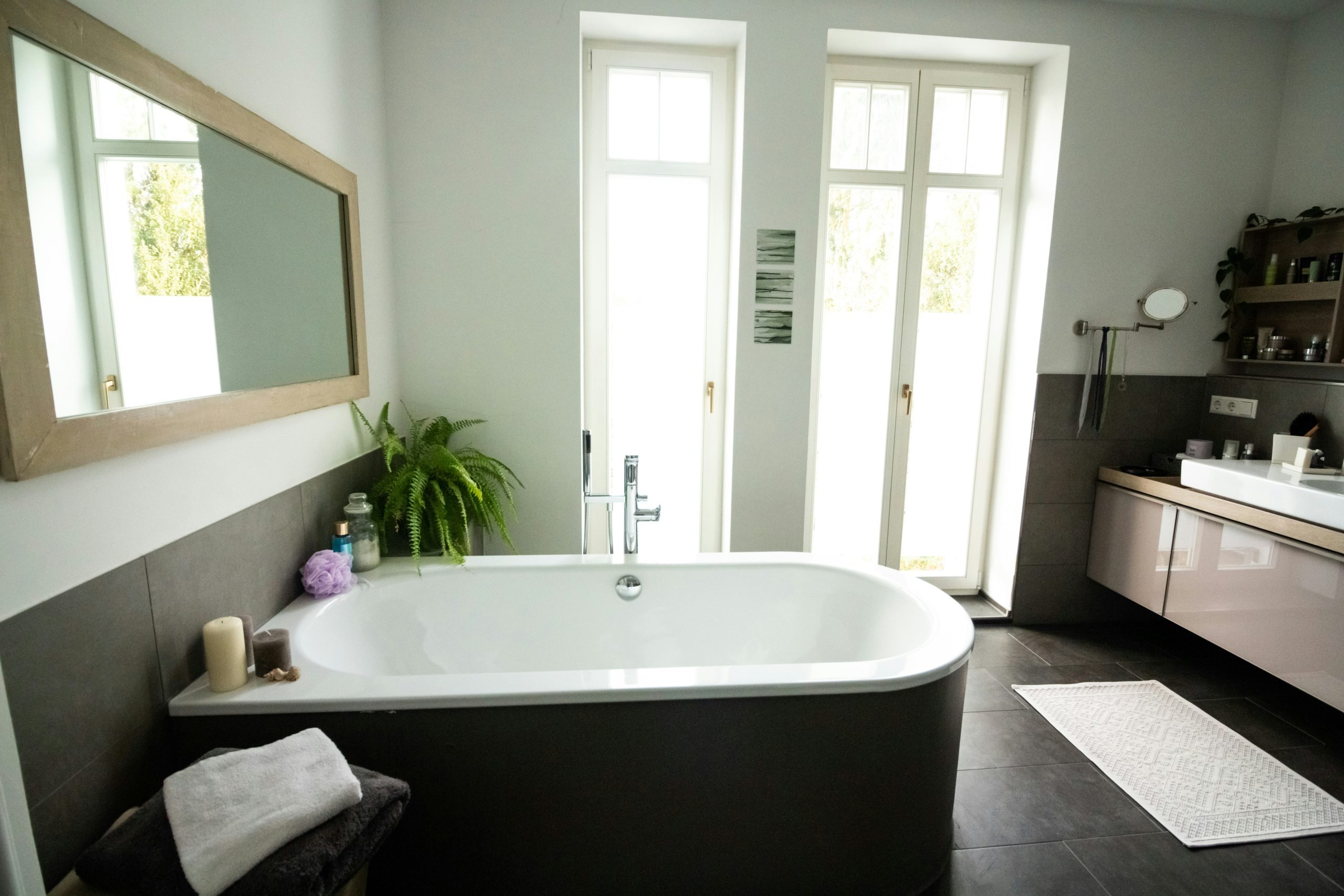 a bathroom with a wooden ceiling and a white bathtub