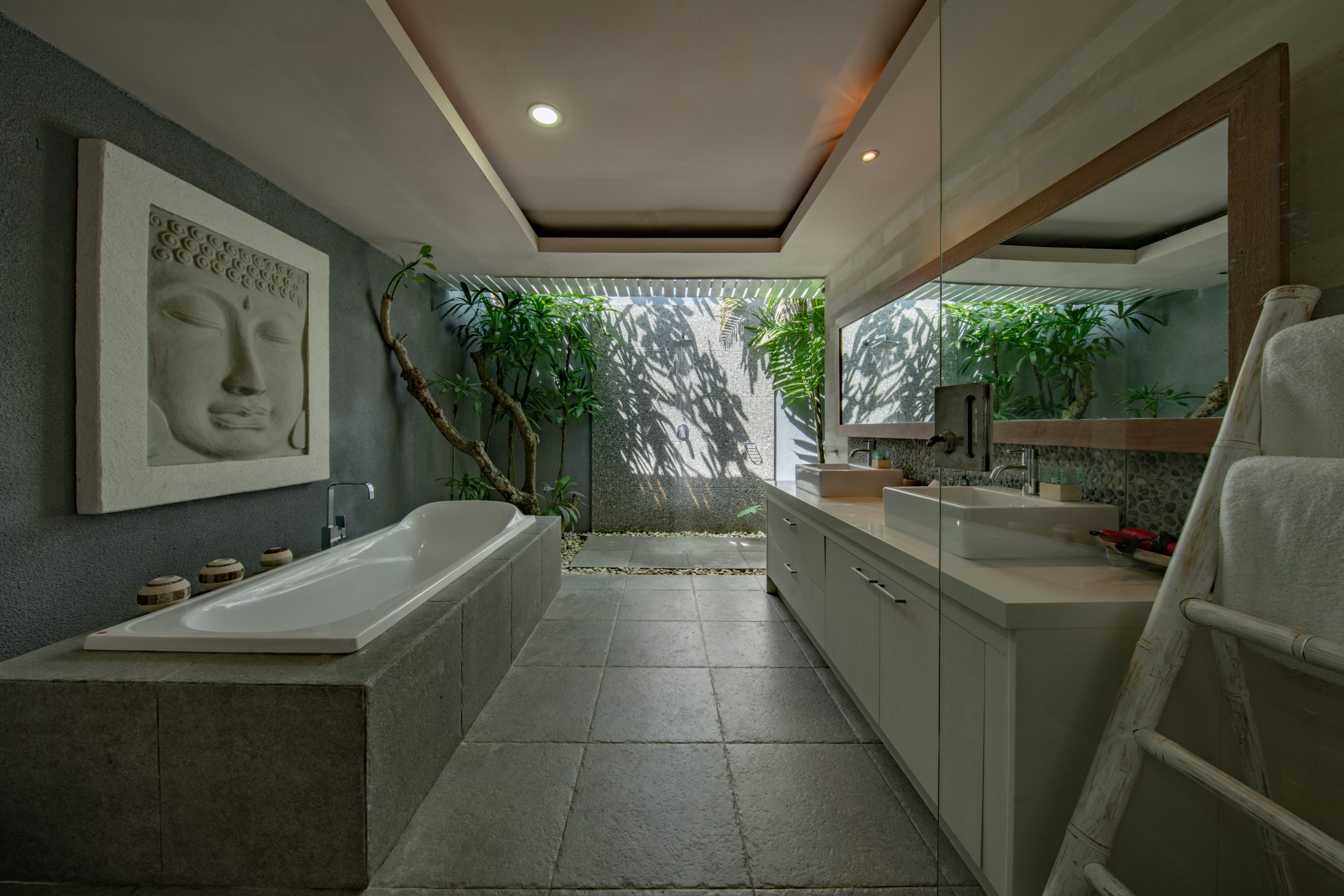 a bathroom with a round tub and a window