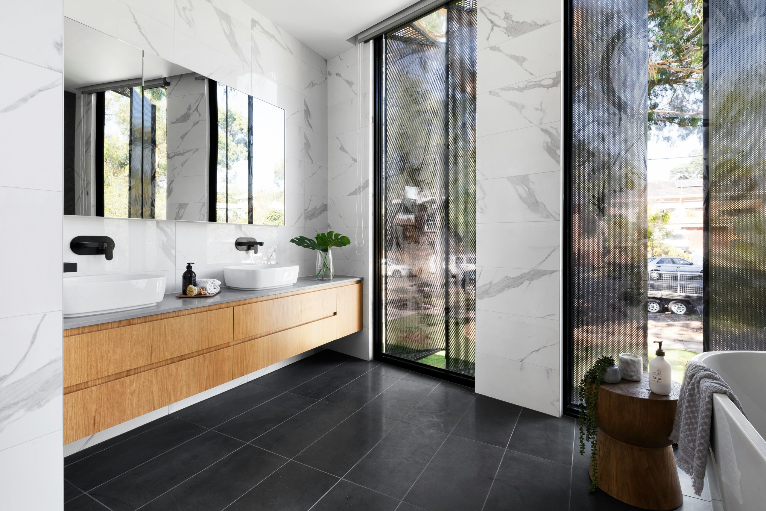 A white bath tub sitting next to a white sink