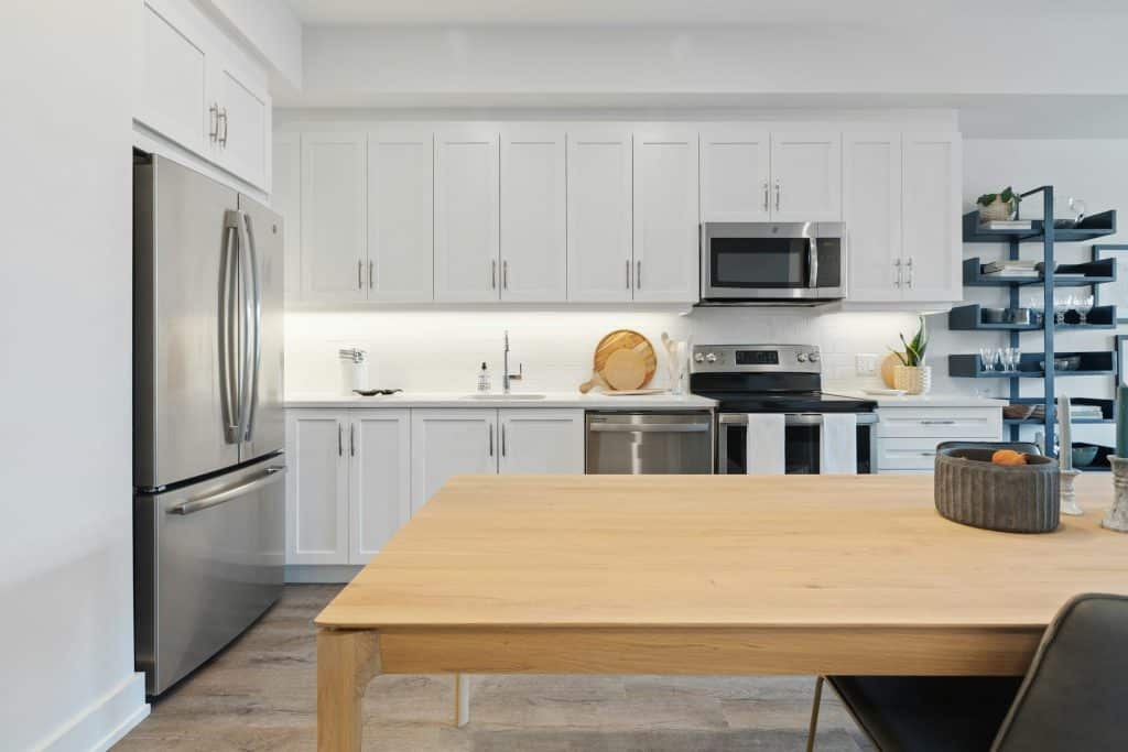 brown wooden table near stainless steel sink